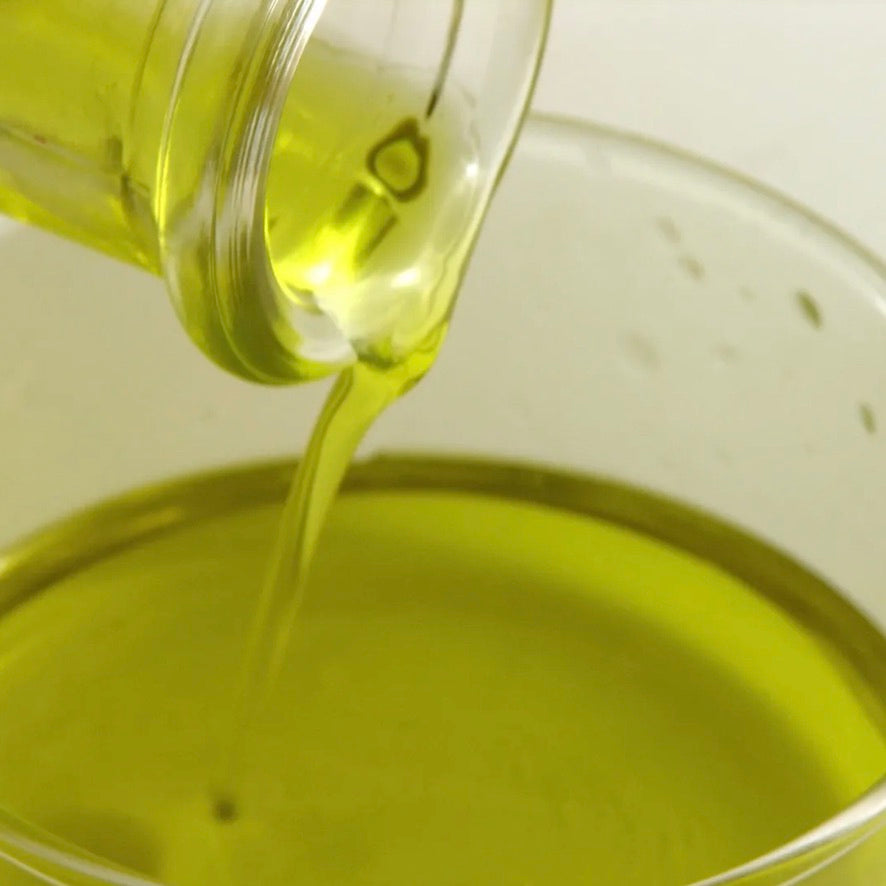 Greek Koroneiki Olive Oil bottle with olives and pasta dish